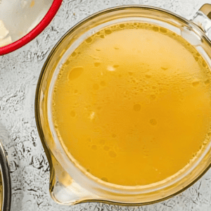 instant pot chicken stock in a glass bowl.