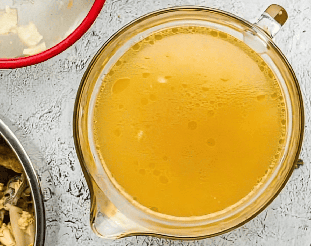 instant pot chicken stock in a glass bowl.