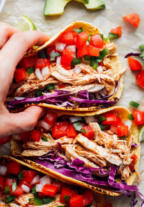 hand holding up instant pot chicken tacos