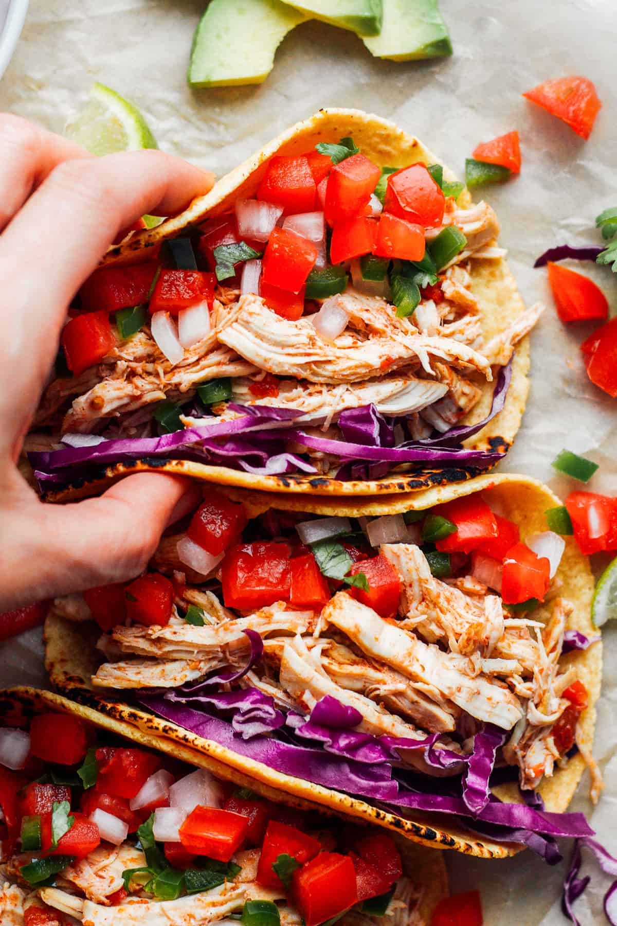 hand holding up instant pot chicken tacos.