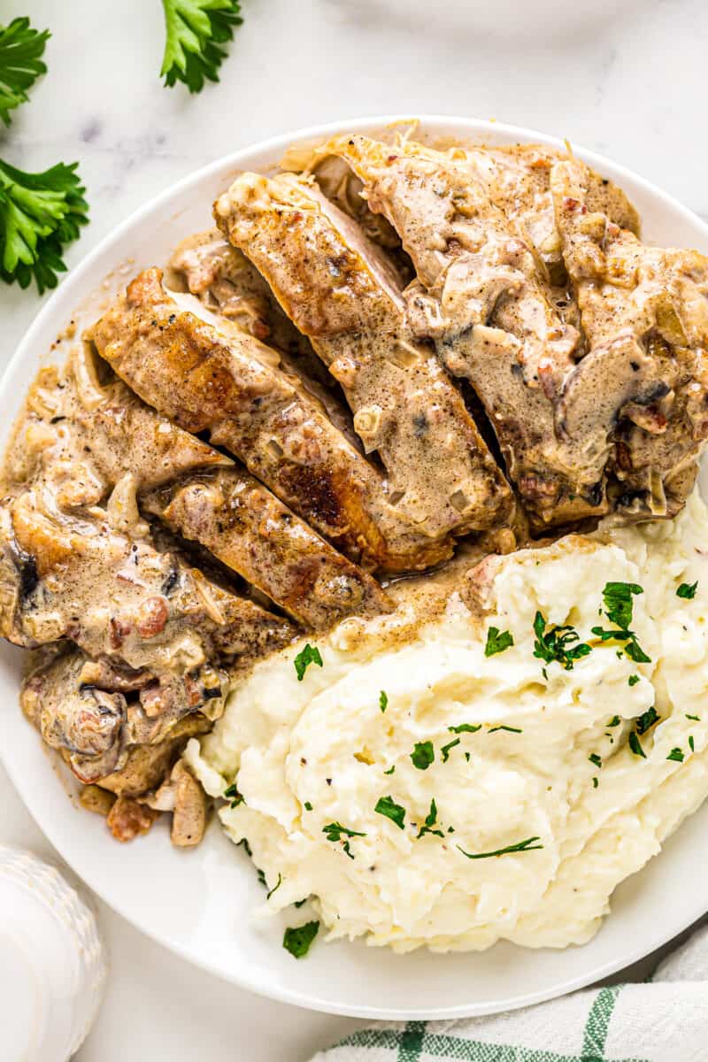 sliced smothered chicken served with mashed potatoes