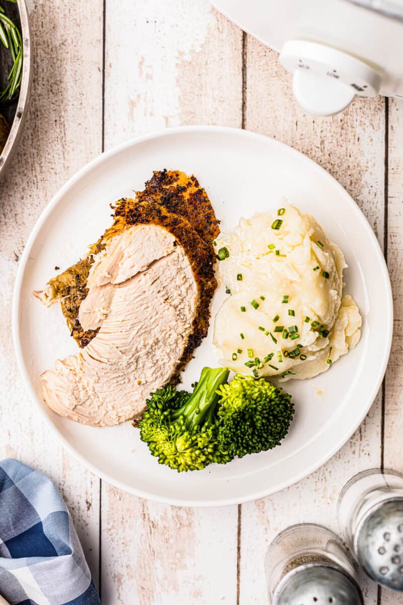 sliced crockpot whole chicken with mashed potatoes and broccoli