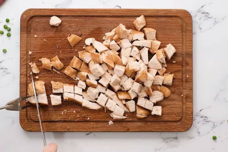 Diced chicken on a chopping board.