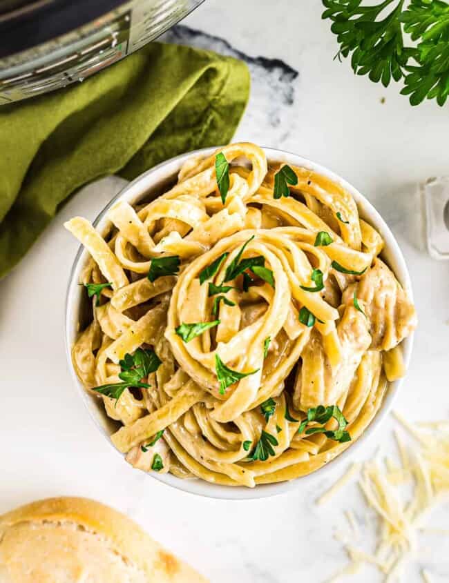 white bowl with instant pot chicken alfredo