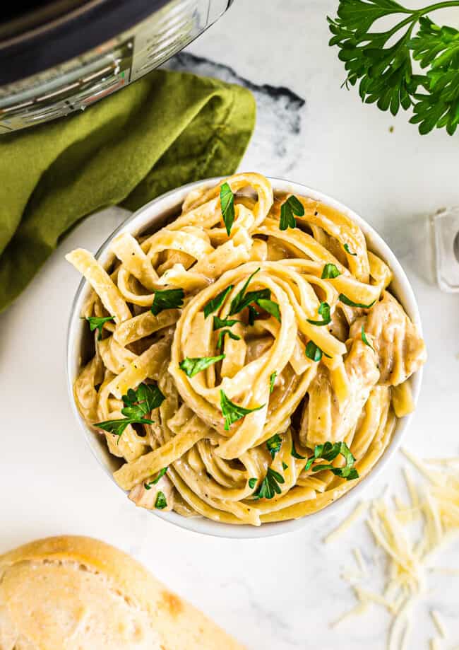 white bowl with instant pot chicken alfredo
