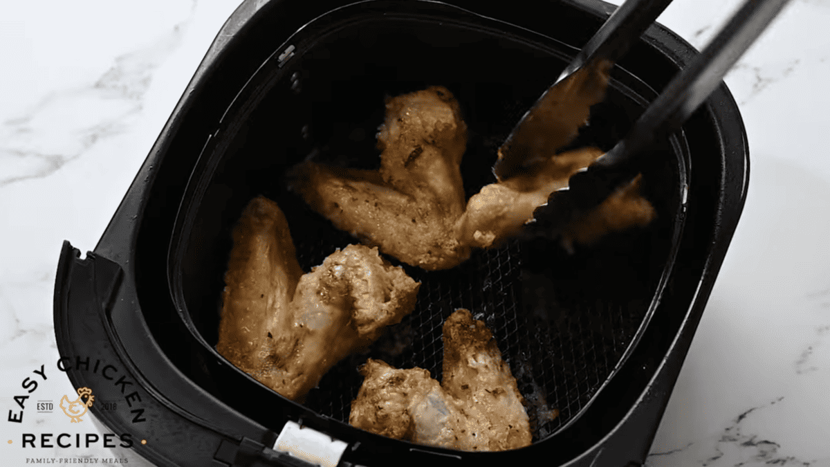 Fried chicken wings in an air fryer.