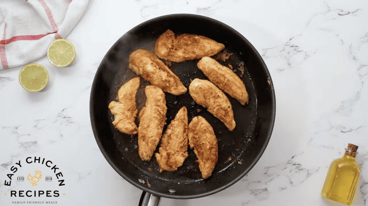 cooked seasoned chicken tenders in a pan.