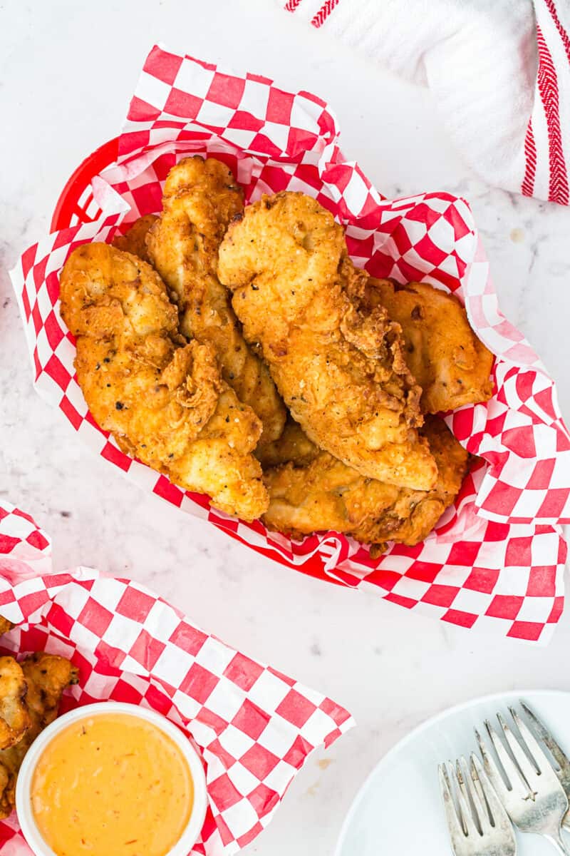two fried chicken tender baskets with honey mustard