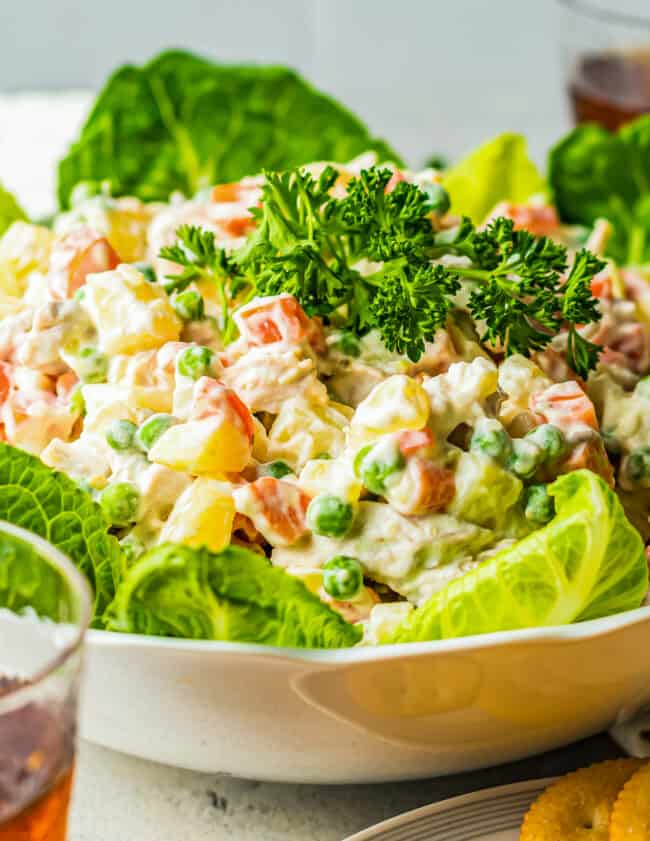 side shot of chicken potato salad over lettuce