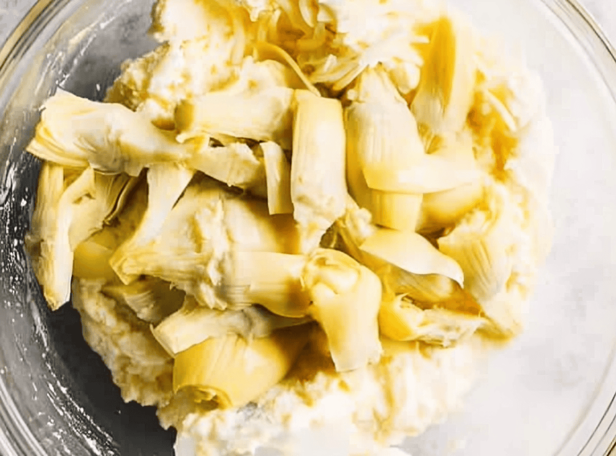 artichokes and cheese in a glass bowl.