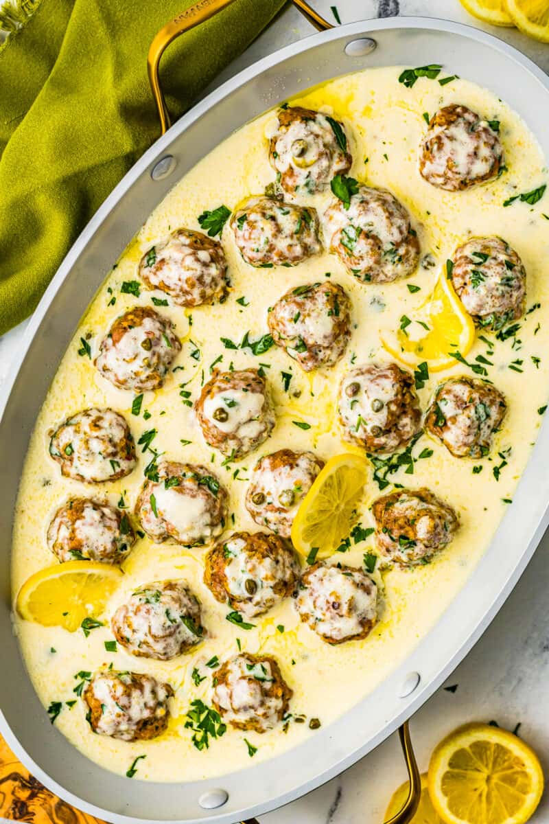 chicken piccata meatballs in sauce on serving dish