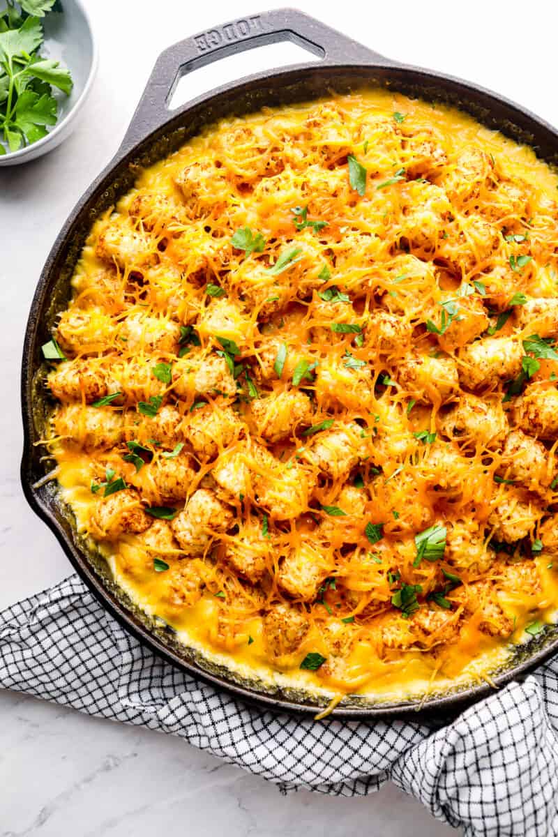 cheesy tater tot chicken casserole in cast iron skillet