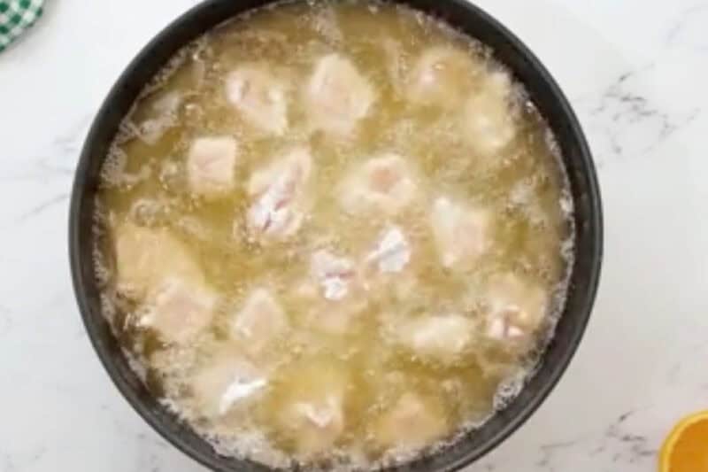 frying breaded chicken pieces in oil.