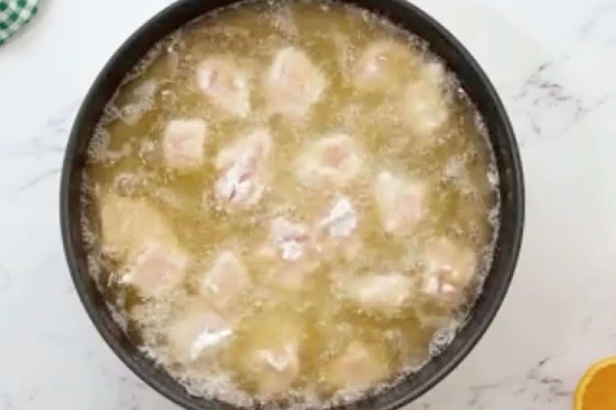frying breaded chicken pieces in oil.