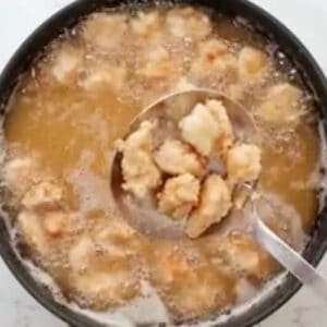 removing fried chicken pieces from oil.