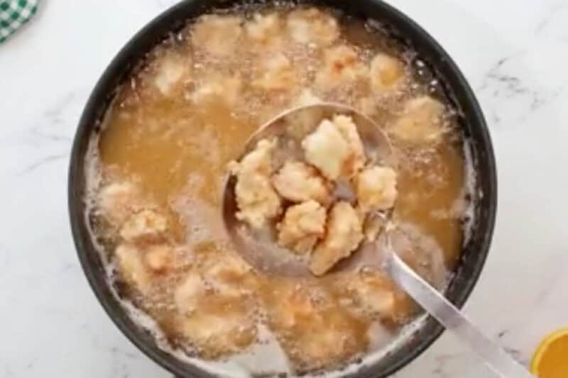 removing fried chicken pieces from oil.
