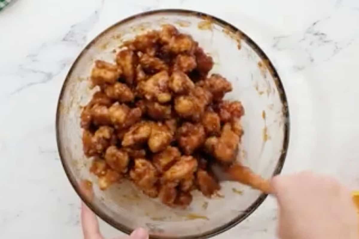 Crispy chicken bites coated in orange sauce.