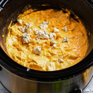buffalo chicken dip in a crockpot with blue cheese.