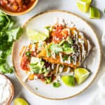 mexican enchiladas on a white plate.