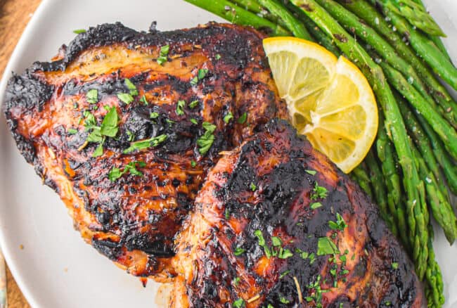 plate of grilled chicken thighs with asparagus