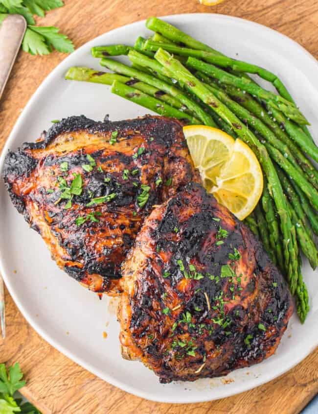 plate of grilled chicken thighs with asparagus