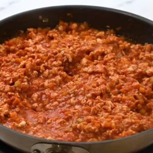 Fully cooked buffalo chicken sloppy joes mixture in a skillet.