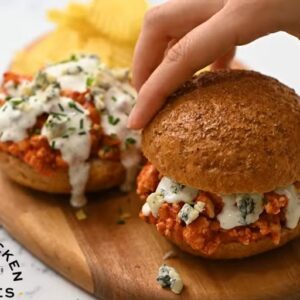 Buffalo chicken sloppy joes topped with ranch dressing, blue cheese crumbles, and chives.