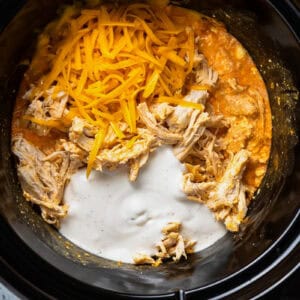 shredded chicken, cheese, and ranch added to creamy buffalo sauce in a crockpot.
