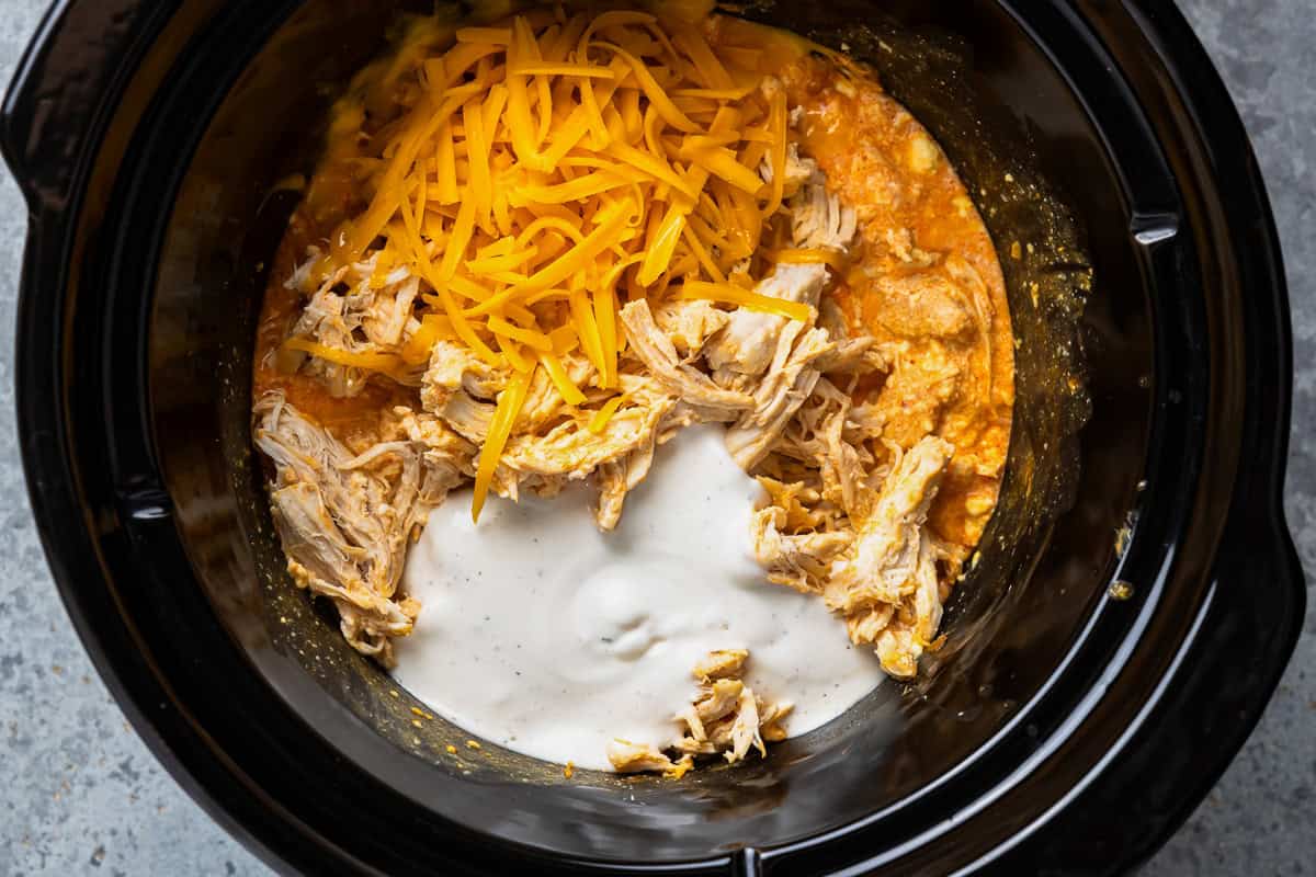 shredded chicken, cheese, and ranch added to creamy buffalo sauce in a crockpot.