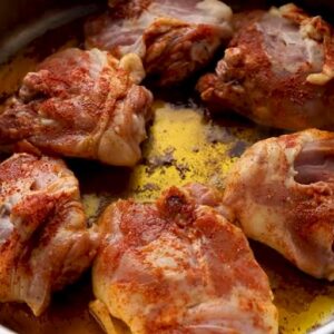 spanish chicken cooking in a skillet