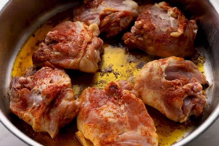 spanish chicken cooking in a skillet