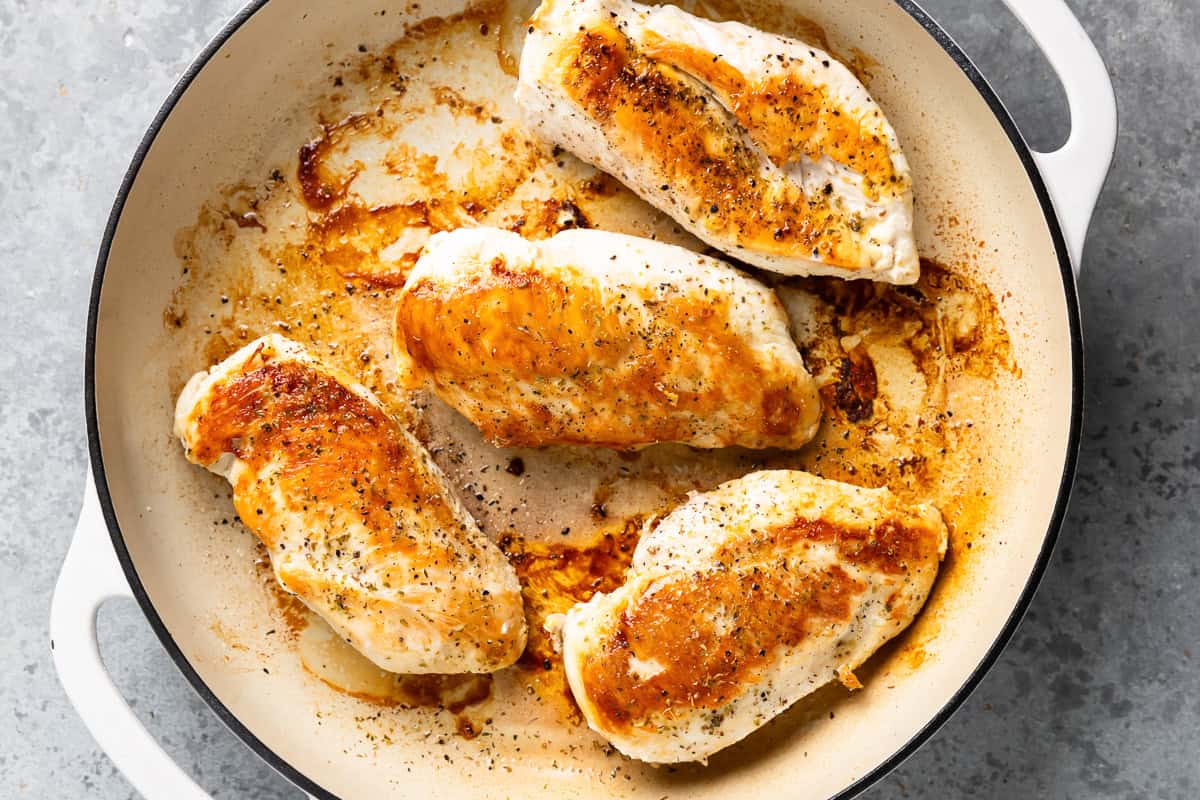 seared chicken breasts in a skillet.