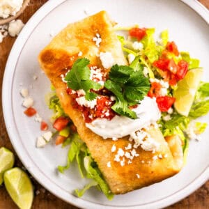 overhead view of a chicken chimichanga on a white plate.