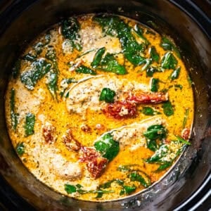 cooked tuscan chicken in a crockpot.