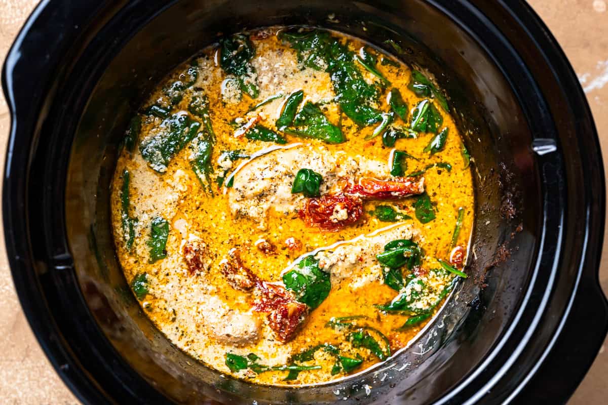 cooked tuscan chicken in a crockpot.