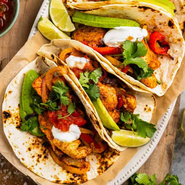 overhead view of air fryer chicken fajitas on a cutting board.