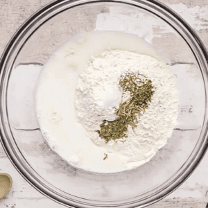 biscuit mix and seasonings in a glass bowl.