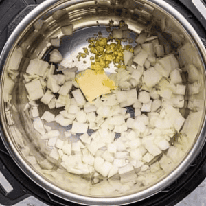 chopped onions, minced garlic, and butter in an instant pot.