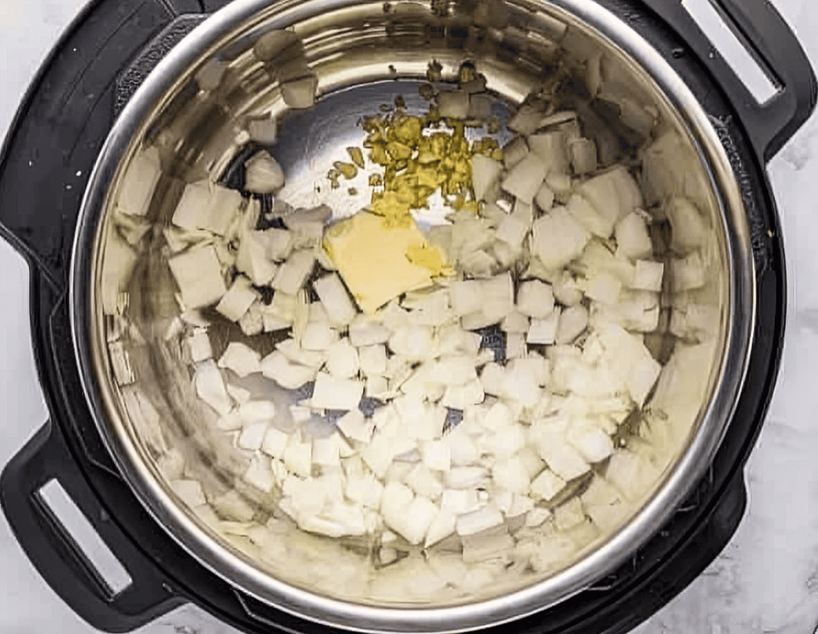 chopped onions, minced garlic, and butter in an instant pot.