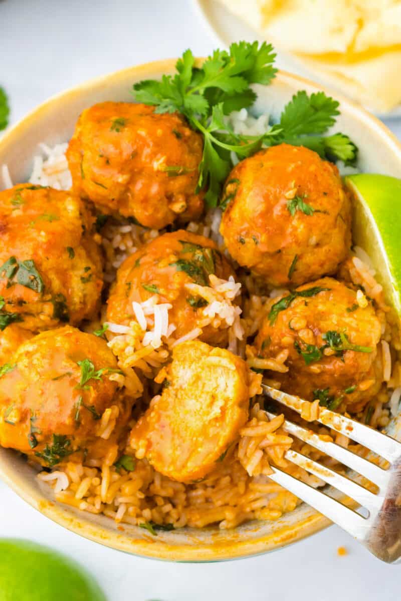 curry chicken meatballs in bowl with rice