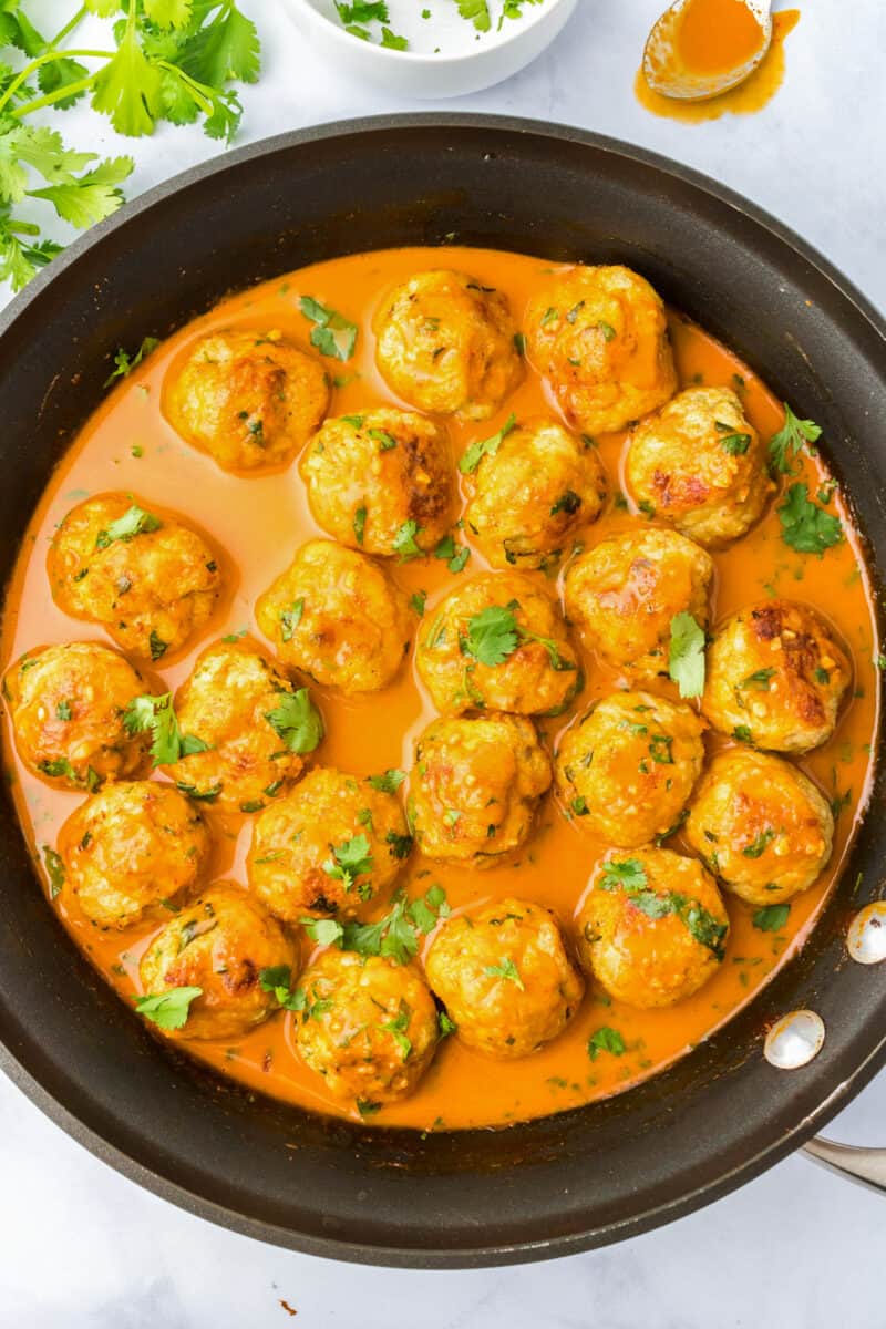curry chicken meatballs in sauce in skillet
