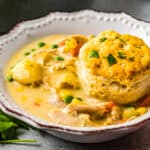 featured bowl of chicken pot pie soup with biscuit