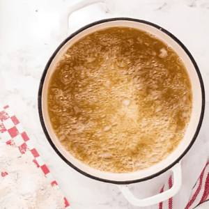 frying chicken tenders in a Dutch oven.