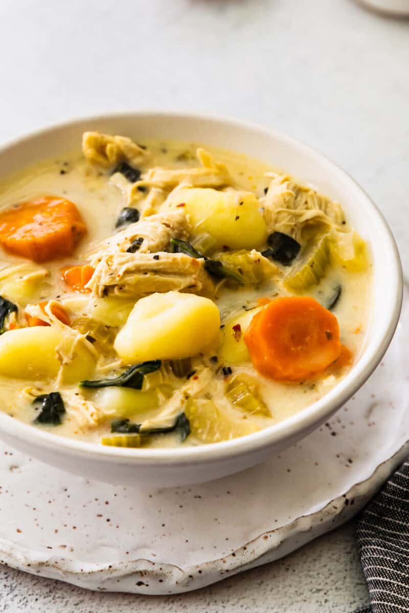 close up chicken gnocchi soup in a white bowl