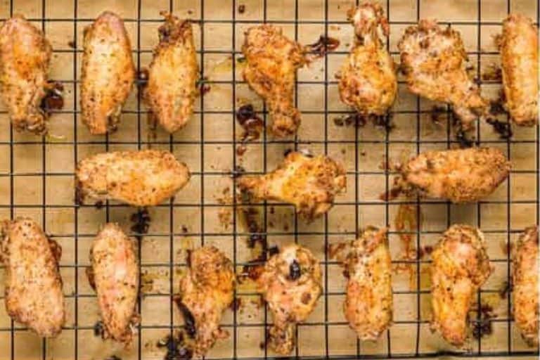 Garlic parmesan wings on a baking rack.