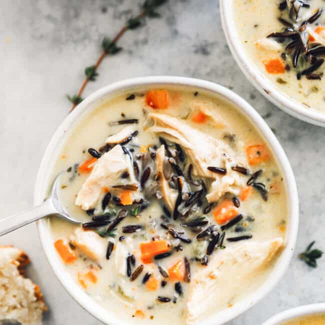 overhead image of chicken wild rice soup in a white bowl with a spoon