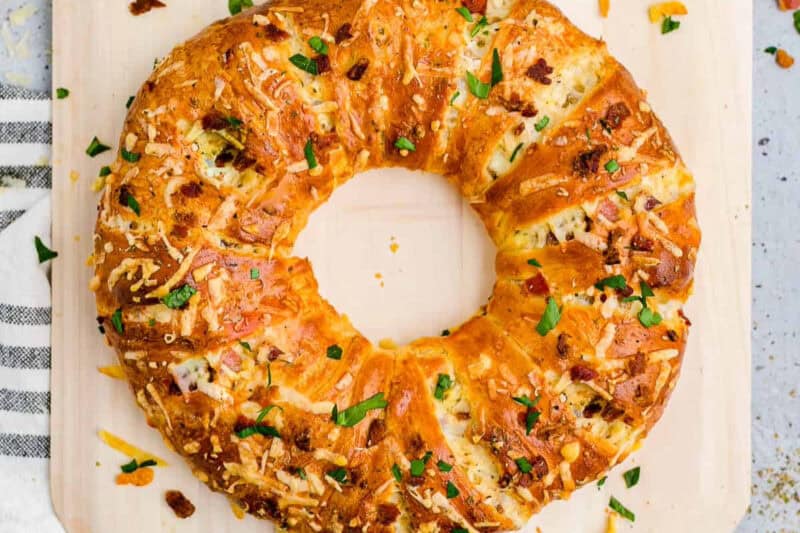 baked chicken alfredo crescent roll topped with bacon and cheese.