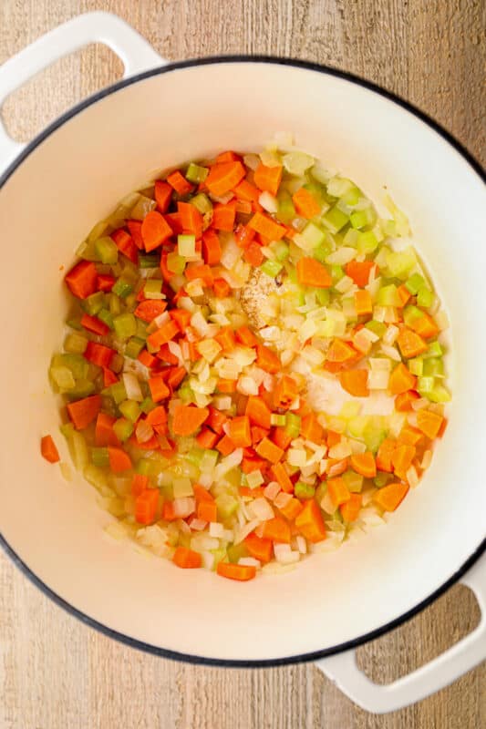 chopped carrots, celery, and onion in a white pot