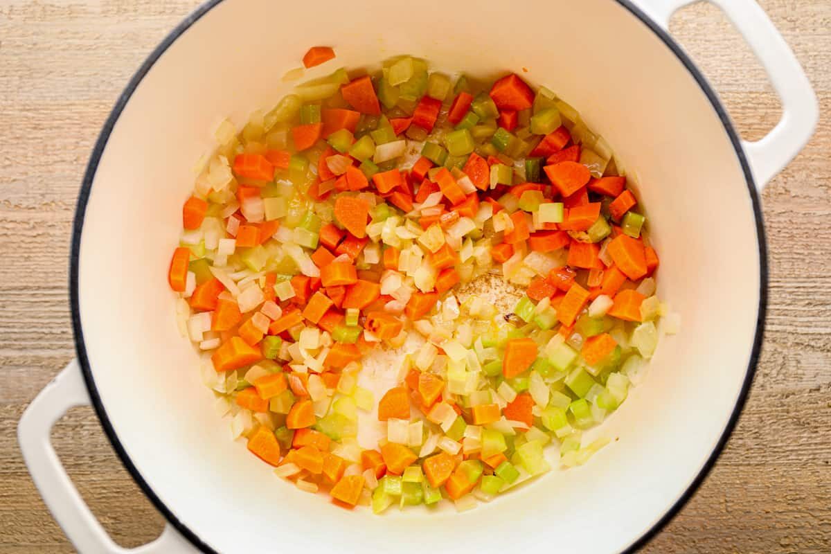 chopped carrots, celery, and onion in a white pot