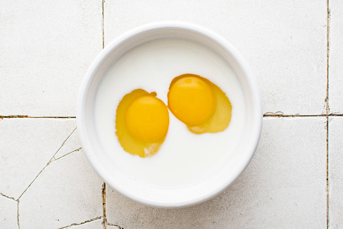 eggs and milk in a white bowl.